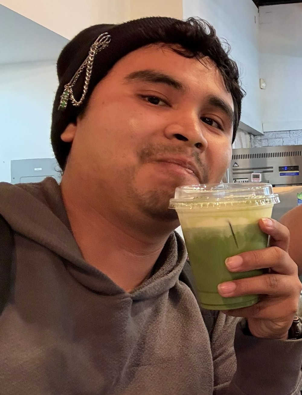 Marco holding a matcha latte